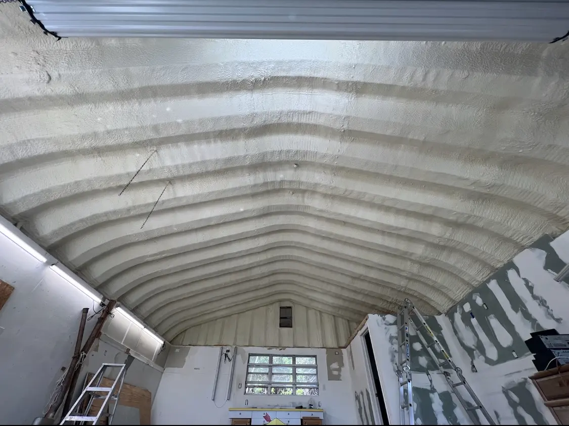 Spray polyurethane foam applied to the underside of a metal roof deck in Pitman